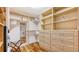Spacious walk-in closet with custom shelving, drawers, and ample hanging space, offering practical storage solutions at 5024 Commonwealth Dr, Sarasota, FL 34242