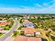 An aerial view of a neighborhood with beautiful homes, lush greenery, and picturesque streets at 10816 O Meara Way, Englewood, FL 34223