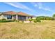 Expansive backyard with well-maintained lawn, paver patio, and screened-in porch offer an ideal outdoor retreat at 10816 O Meara Way, Englewood, FL 34223