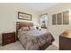 Comfortable bedroom provides a tranquil retreat with stylish decor and soft, natural light at 10816 O Meara Way, Englewood, FL 34223