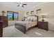 Bright bedroom boasts natural light, elegant furnishings, and a relaxing ambiance at 10816 O Meara Way, Englewood, FL 34223