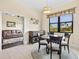 Cozy dining area with a round table, stylish chairs, and scenic views from the window at 10816 O Meara Way, Englewood, FL 34223