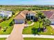 Beautiful home featuring a paver driveway, tile roof, two-car garage, and well-manicured landscaping at 10816 O Meara Way, Englewood, FL 34223