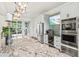 Elegant kitchen featuring stainless steel appliances, granite countertops, and a view of the outdoors at 10816 O Meara Way, Englewood, FL 34223
