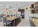 Open concept kitchen has a granite island, stainless appliances and adjacent living space at 10816 O Meara Way, Englewood, FL 34223