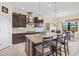 Well-equipped kitchen with granite island, stainless appliances, pendant lighting and backsplash at 10816 O Meara Way, Englewood, FL 34223