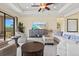 Comfortable living room featuring tray ceilings, neutral decor, and stylish furnishings at 10816 O Meara Way, Englewood, FL 34223