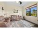 Comfortable living area features a cozy leather sofa, mirror and a bright window view at 10816 O Meara Way, Englewood, FL 34223