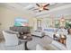 Bright living room with tray ceilings, neutral decor, and stylish furnishings at 10816 O Meara Way, Englewood, FL 34223