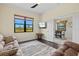 Comfortable living room features stylish decor, a scenic view, and seamless access to the dining area at 10816 O Meara Way, Englewood, FL 34223