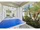 Inviting outdoor recreation area with a ping pong table, lush landscaping, and a glimpse of the pool at 10816 O Meara Way, Englewood, FL 34223