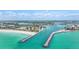 Scenic aerial view of inlet on the Gulf Coast with jetties, a beach, and bright blue water at 1358 Cielo Ct, North Venice, FL 34275