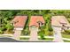Aerial view of the house with a red tile roof, manicured lawn, and proximity to a pond at 1358 Cielo Ct, North Venice, FL 34275