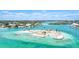 Stunning aerial shot of a coastal community showcasing homes, boats, and vibrant turquoise waters at 1358 Cielo Ct, North Venice, FL 34275
