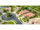 Overhead view of a home with red tile roof, driveway, and a nearby pond surrounded by trees at 1358 Cielo Ct, North Venice, FL 34275