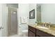 Bathroom features walk-in shower with glass door, granite countertop vanity and light blue walls at 1358 Cielo Ct, North Venice, FL 34275