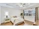 Relaxing bedroom boasts a ceiling fan, large window, and hardwood flooring at 1358 Cielo Ct, North Venice, FL 34275