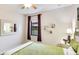 Cozy bedroom features a ceiling fan, window with curtains, and decorative wall accents at 1358 Cielo Ct, North Venice, FL 34275