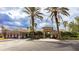 Community clubhouse featuring a tile roof, mature trees and well-maintained landscaping at 1358 Cielo Ct, North Venice, FL 34275