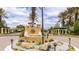 Community entrance featuring a decorative fountain and beautifully landscaped grounds at 1358 Cielo Ct, North Venice, FL 34275