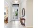 Bright entryway featuring tile floors, a decorative mirror, and a clear view to the outdoors at 1358 Cielo Ct, North Venice, FL 34275
