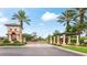 Gated community entrance with lush landscaping and decorative elements at 1358 Cielo Ct, North Venice, FL 34275