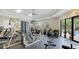 Bright community gym featuring exercise machines, free weights, and views of the pool outside at 1358 Cielo Ct, North Venice, FL 34275