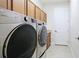 Bright laundry room with modern LG washer and dryer set, and plenty of cabinet space at 1358 Cielo Ct, North Venice, FL 34275