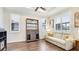 Inviting living room with a white sofa, shuttered windows, and a decorative bookshelf at 1358 Cielo Ct, North Venice, FL 34275