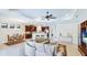 Open concept living space with kitchen bar, dining table, and entertainment center at 1358 Cielo Ct, North Venice, FL 34275