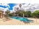 Inviting pool area with clear blue water, palm trees, and comfortable lounge chairs for relaxation at 1358 Cielo Ct, North Venice, FL 34275
