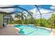 Inviting screened-in pool featuring a sun shelf, brick paver deck, and lush tropical landscaping at 1358 Cielo Ct, North Venice, FL 34275