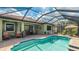 Inviting screened-in pool area complete with outdoor seating and lush landscaping for ultimate relaxation at 1358 Cielo Ct, North Venice, FL 34275