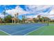 A meticulously maintained tennis court with lush green surroundings and a charming gazebo at 1358 Cielo Ct, North Venice, FL 34275