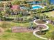 Stunning aerial view of the community playground, pool, and amenities in a beautiful setting with lush landscaping at 14309 Carolina Sky Pl, Lakewood Ranch, FL 34211