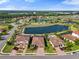 Wide aerial view of a residential community with tiled-roof homes, lakes, landscaping, and neighborhood streets at 14309 Carolina Sky Pl, Lakewood Ranch, FL 34211