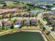 Aerial shot showcasing a community with lakes, pools, and neatly arranged residences with tile roofs at 14309 Carolina Sky Pl, Lakewood Ranch, FL 34211