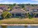 Lush backyard with screened lanai, showcasing the property's proximity to a serene lake and landscaping at 14309 Carolina Sky Pl, Lakewood Ranch, FL 34211