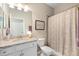 Bathroom features a shower/tub combo, granite countertop, and neutral decor at 14309 Carolina Sky Pl, Lakewood Ranch, FL 34211