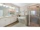 Luxurious bathroom with double vanity, soaking tub, and glass shower at 14309 Carolina Sky Pl, Lakewood Ranch, FL 34211