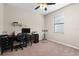 A cozy bedroom with a desk, chair, and window that could be used as an office space at 14309 Carolina Sky Pl, Lakewood Ranch, FL 34211
