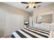 This bedroom features a nautical theme, a large closet, and a ceiling fan at 14309 Carolina Sky Pl, Lakewood Ranch, FL 34211