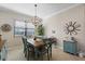 Bright dining area featuring a modern light fixture, seating for four, and coastal-themed decor at 14309 Carolina Sky Pl, Lakewood Ranch, FL 34211