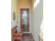 Inviting front entrance with a decorative glass door, bench seating, and warm, textured walls at 14309 Carolina Sky Pl, Lakewood Ranch, FL 34211