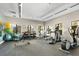 Well-equipped fitness center featuring modern exercise machines, free weights, and ample natural light from large windows at 14309 Carolina Sky Pl, Lakewood Ranch, FL 34211