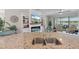Kitchen sink with granite countertops and a view of the open living area and lanai at 14309 Carolina Sky Pl, Lakewood Ranch, FL 34211