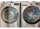 Laundry area features a washer and dryer with shelving at 14309 Carolina Sky Pl, Lakewood Ranch, FL 34211