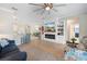 Spacious living area with modern fireplace, TV, and an open layout to the dining and kitchen areas at 14309 Carolina Sky Pl, Lakewood Ranch, FL 34211