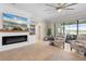 Bright living room with a modern fireplace, built-ins, and view of the outdoor pool at 14309 Carolina Sky Pl, Lakewood Ranch, FL 34211
