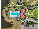 Aerial view of the community pool and clubhouse with ample seating, lush landscaping, and scenic lake views at 14309 Carolina Sky Pl, Lakewood Ranch, FL 34211